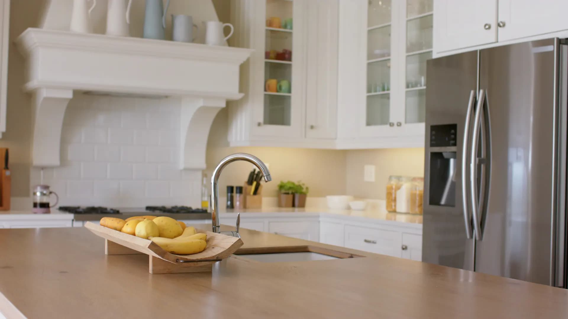 Kitchen island with a wooden bowl of fresh fruit